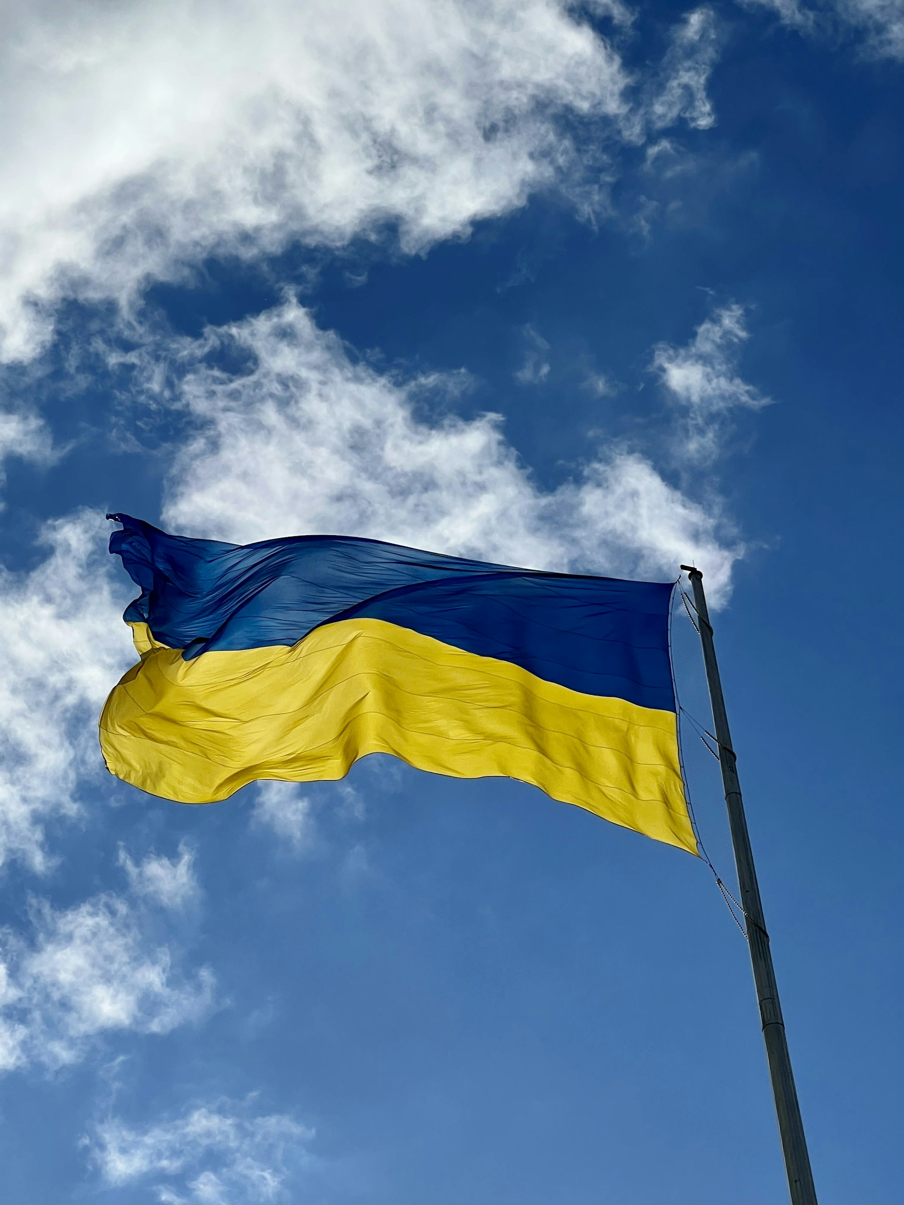 Ukrainian flag waving against a blue sky